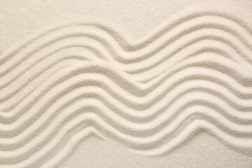 White sand with pattern as background, top view. Zen concept