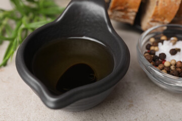 Saucepan of organic balsamic vinegar with oil and spices on beige table, closeup