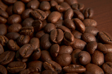 Aromatic Elegance: A close-up masterpiece capturing the intricate details of coffee beans on a rich wooden texture. The interplay of texture and aroma unfolds against a warm backdrop