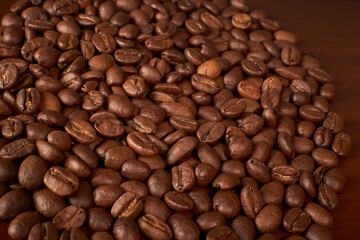 Obraz premium Aromatic Elegance: A close-up masterpiece capturing the intricate details of coffee beans on a rich wooden texture. The interplay of texture and aroma unfolds against a warm backdrop