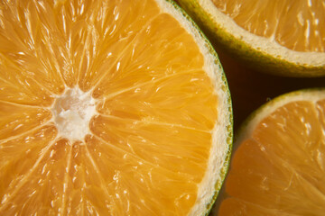 Citrus Unveiled: An intimate and detailed macro shot of a split-open orange, revealing its succulent texture and vibrant segments. The capture offers a tantalizing glimpse of nature's juicy