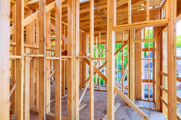 Work in progress interior view of new unfinished house with wooden beams