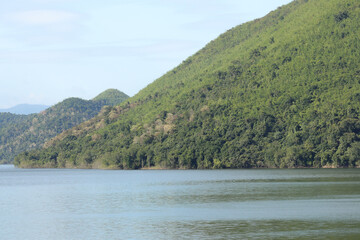 Lake beautiful landscape. Forest background and textured flowing of small waves. 