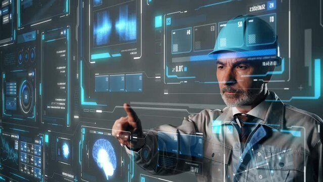 Middle aged engineer touching futuristic holographic graphical user interface. Industrial technology.