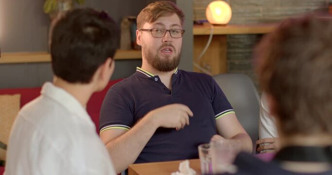 Man business coach actively delivering information during workshop at the table. Importance of effective communication and speakers role in ensuring message is received as intended. Verbal messages.