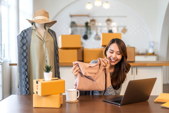 Portrait of owner asian woman freelancer sme business online shopping working checklist order and packing product, cardboard box, E-commerce, marketing, entrepreneur, Business online, startup concept