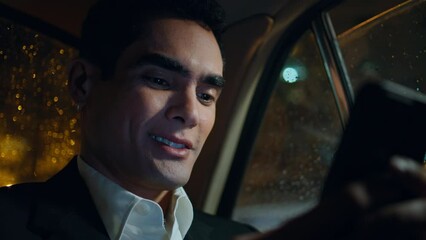 Closeup smiling employee messaging telephone at vehicle. Man reading smartphone