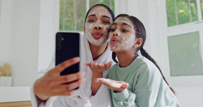 Selfie, mother and facial of kid with peace sign in bathroom skincare, bonding or wellness. Face mask, beauty of mom and girl happy in cosmetics, healthy and blow air kiss on profile picture at home