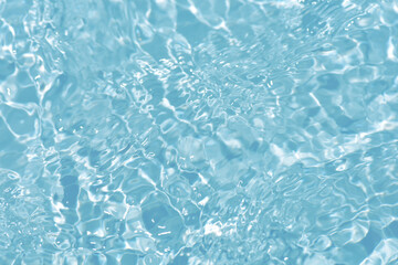  Blue water with ripples on the surface. Defocus blurred transparent blue colored clear calm water surface texture with splashes and bubbles. Water waves with shining pattern texture background.