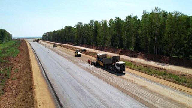 Road construction works, aerial shot. Laying sand. Preparation for asphalting the road surface. August 2023. Republic of Tatarstan