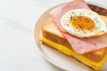 bread toasted cheese topped ham and fried egg with pork sausage