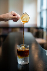 how to make iced americano coffee in the cafe.selective focus