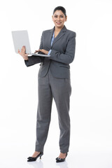 Young Indian businesswoman working on a laptop at isolated on white studio background.