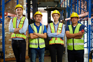 group of workers folded arms pose in the warehouse storage