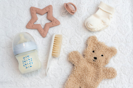Collection of newborn's accessories in top view, essential things for infant comfort and care, flat lay style