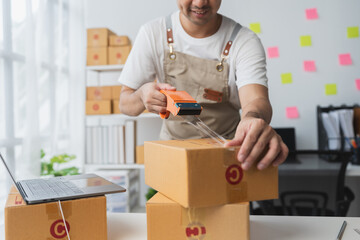 Independent entrepreneurs use scotch tape to attach parcel boxes to prepare goods for the process of packaging, shipping, online sales internet marketing ecommerce concept startup business ideas