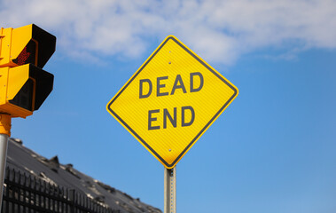 Dead End sign stands against a desolate backdrop, embodying finality, halted progress, and the need...