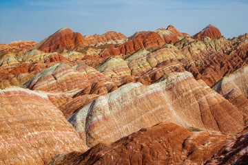 Fantastic View of Rainbow Mountains Geological Park. Stripy Zhangye Danxia Landform Geological Park in Gansu Province, China. Valley on a Sunny Day during the sunset