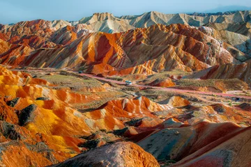 Photo sur Plexiglas Zhangye Danxia The way through the rainbow Colorful rock formations in the Zhangye Danxia Landform Geological Park. Rainbow mountain in China. Blue sky with copy space