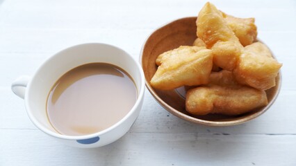 Breakfast, fresh coffee, milk, fried dough, a soft outer frame in a slightly salty taste.