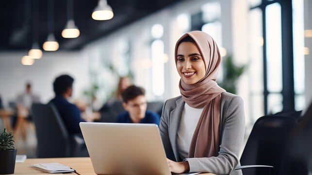 arab saudi person using a laptop computer on her desk office