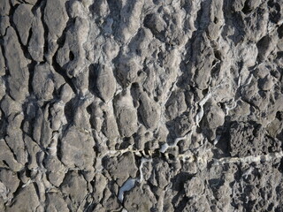 Grooves of gray-black rocks caused by natural water erosion.