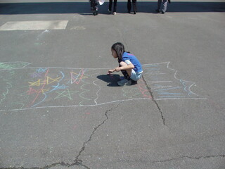 child playing with chalk