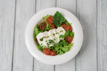 Green vegan salad from green leaves mix and vegetables.