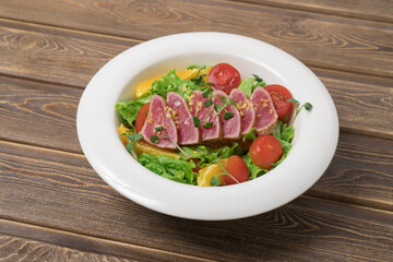 Salad with pieces of tuna on a plate