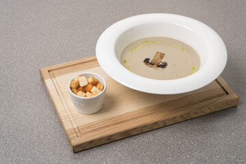 Mushroom cream soup on wooden background