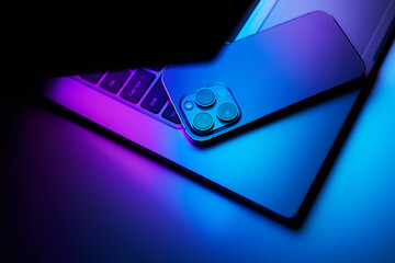 Laptop with smartphone. Neon dark light. - 639772531