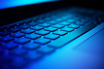 Close up image of laptop keyboard in dark neon light. - 639772586