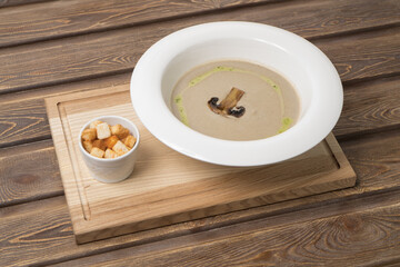 Mushroom cream soup on wooden background