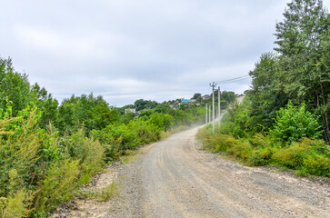 Fototapeta na wymiar gravel road in Verkhnii Nergen village (Nanaysky district, Khabarovsk krai, Russia)