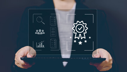 Businesswoman using laptop computer with quality assurance and document icon for ISO or International Standard Organisation which related quality control and continuous improvement concept.