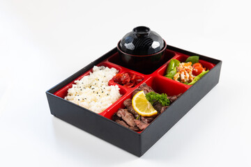 Top view Japanese food bento box set with grilled beef, Rice Salad and Main Course. Japanese food isolated on white background