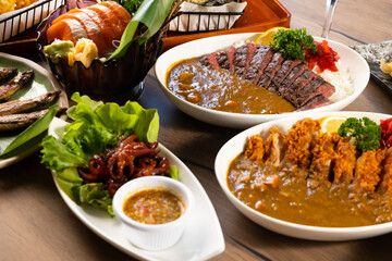 Top view spicy curry meat food in plate with rice. many traditional gourmet japanese food dishes on wood table. Japanese food isolated on wood background