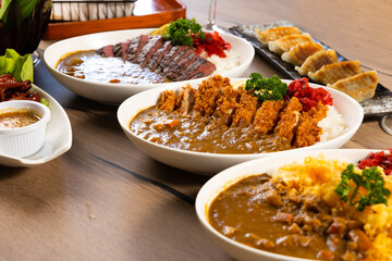 Top view spicy curry meat food in plate with rice. many traditional gourmet japanese food dishes on wood table. Japanese food isolated on wood background