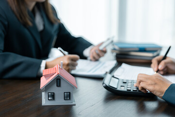 Banks approve loans to buy homes. Real estate agents explain the document for customers who come to...