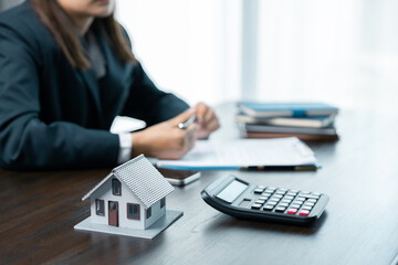 Banks approve loans to buy homes. Real estate agents explain the document for customers who come to...