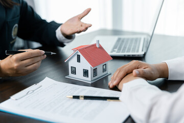 Banks approve loans to buy homes. Real estate agents explain the document for customers who come to...
