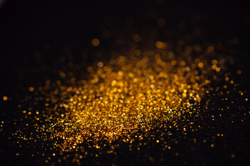 The golden flakes are scattered on the black surface