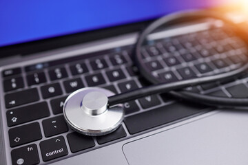 Computer, stethoscope and online for medical advice, professional, or expert in healthcare, cardiology and care. Contact us, laptop and pc keyboard to search for nurse, doctor or health specialist