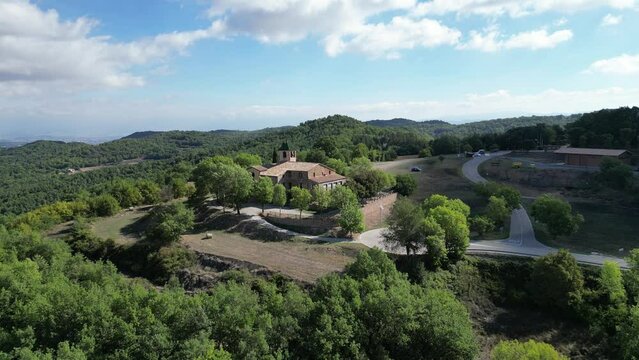 Aerial footage of a chapel and cementery in the middle of the forest.
