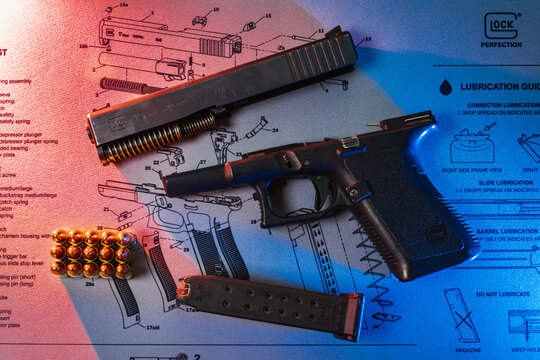 Baltic States August 25, 2023.  Disassembled gun Glock 19 for cleaning, colored led lighting.