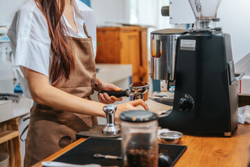 Barista hands coffee barista woman make hot cup espresso shot from coffee machine.