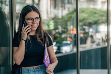 teenage student girl using phone outside school