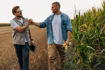 Two men greeting each other in the field.