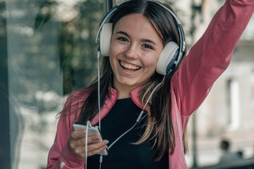 funny happy girl with headphones on the street
