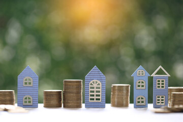 Mortgage,Model house and stack of coins money on natural green background,Business investment and...